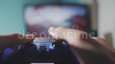 在电视上玩电子游戏机。 手握新的操纵杆在线视频控制台在电视上。 玩家玩游戏游戏与游戏本